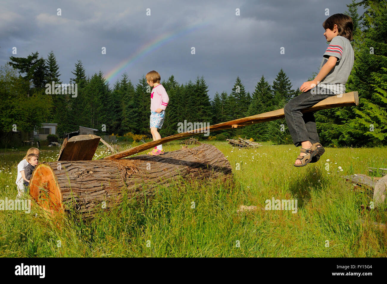 Sunshine and rainbow, kids on teeter totter, Comox, British Columbia