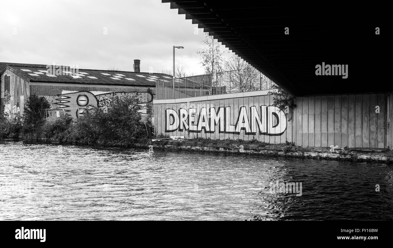 Graffiti next to a canal with the word 'Dreamland' on it. Black and White. Stock Photo