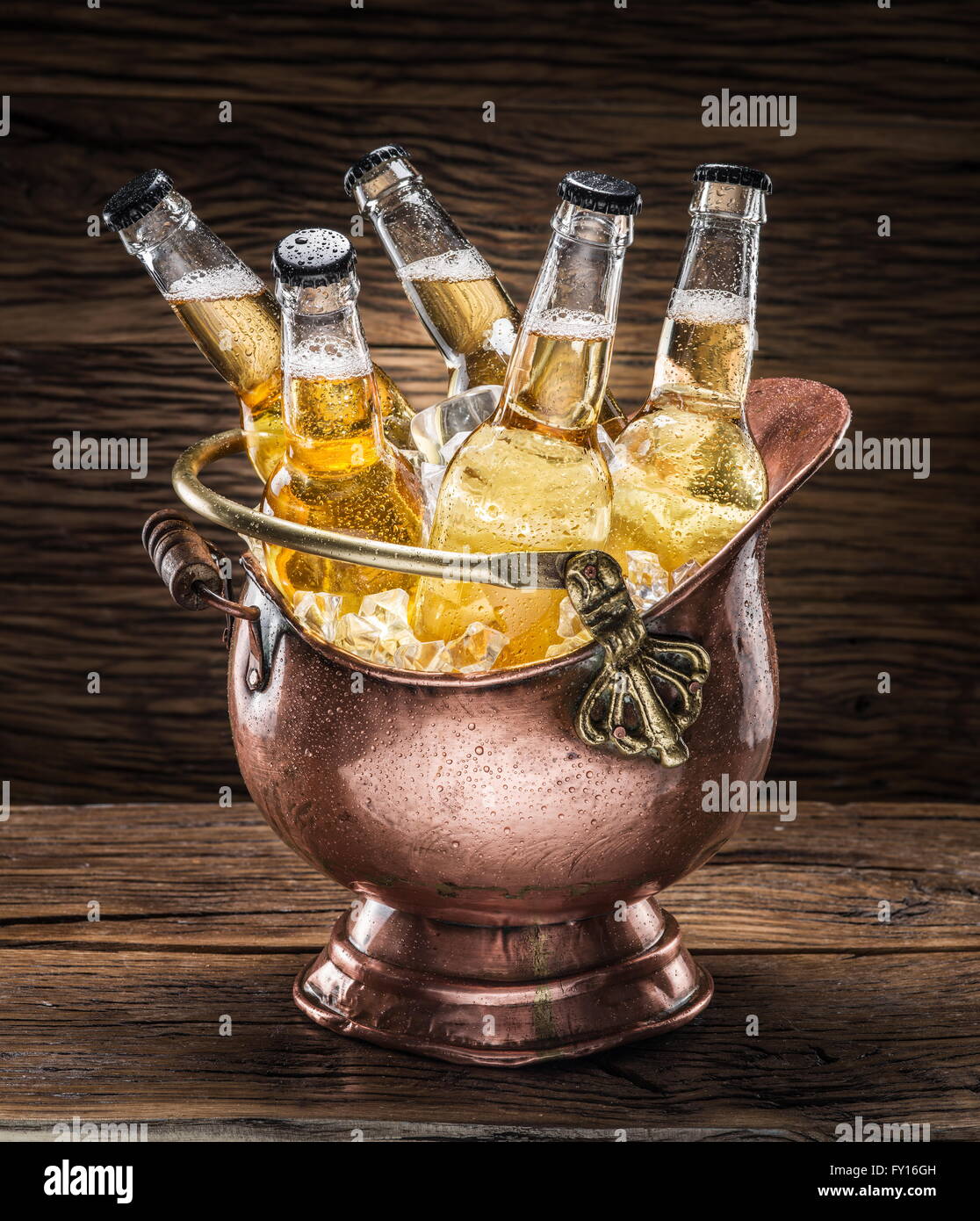 https://c8.alamy.com/comp/FY16GH/cold-bottles-of-beer-in-the-brazen-bucket-on-the-wooden-table-FY16GH.jpg