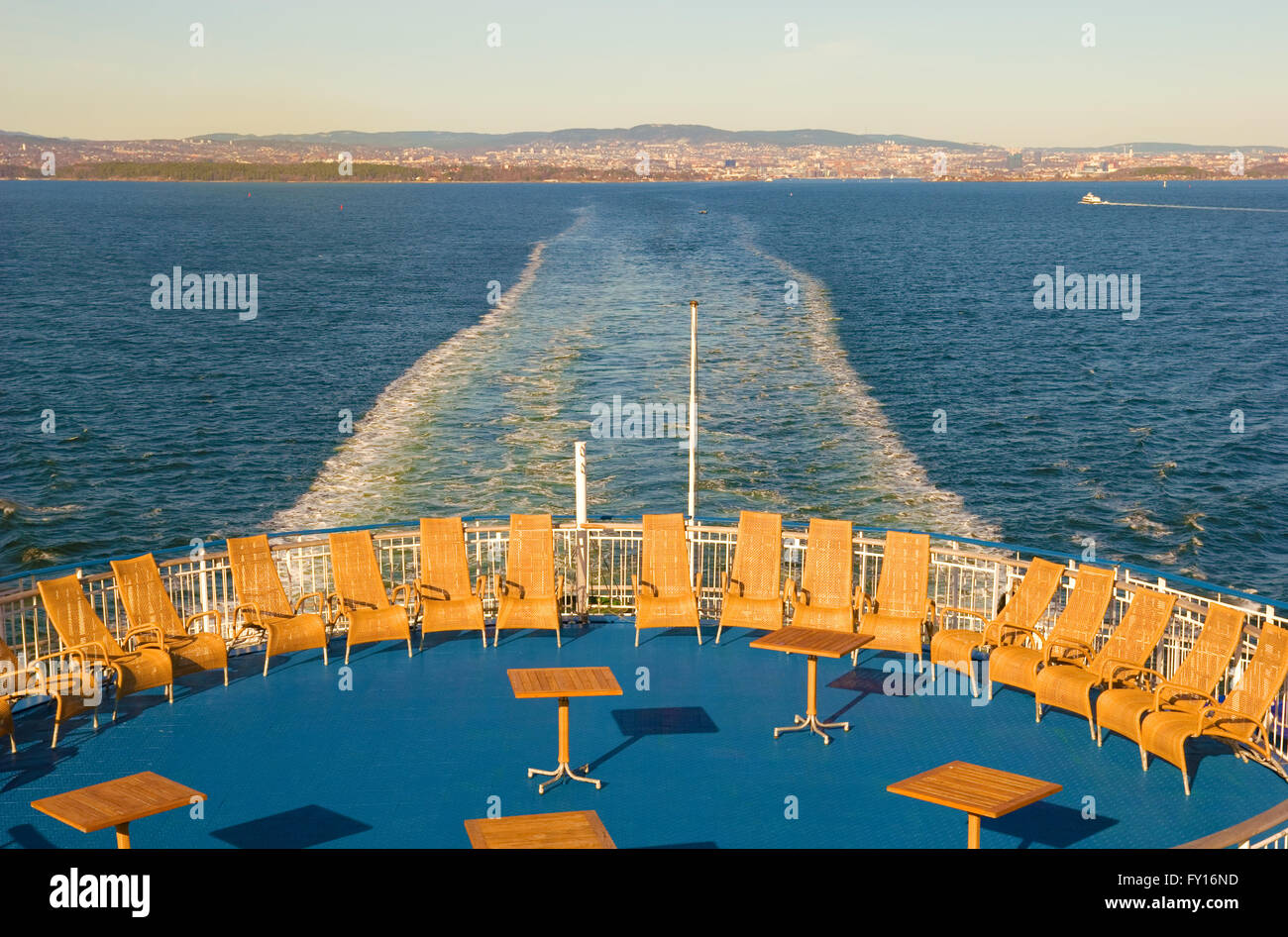 Wicker chairs on the ferry. On the background is Oslo Stock Photo