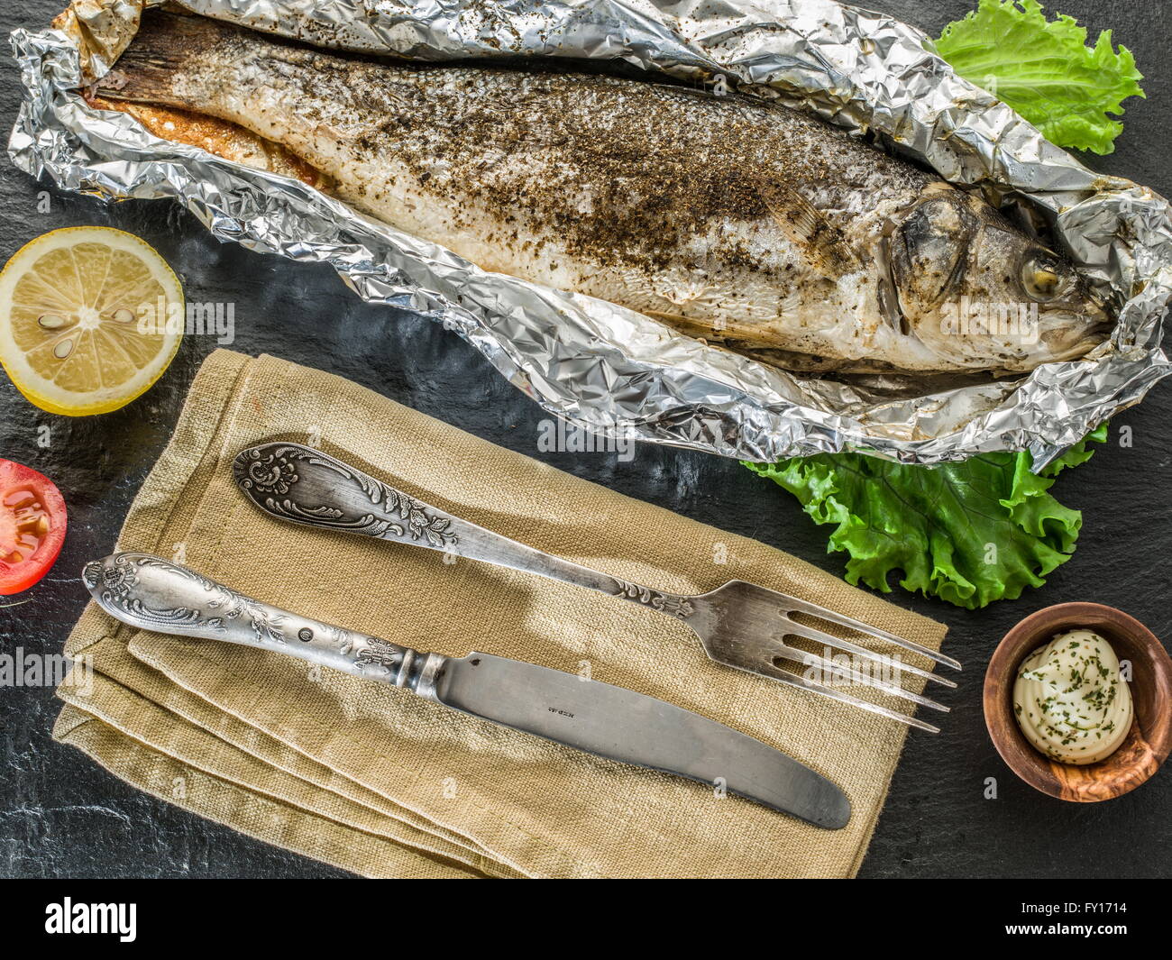 Grilled sea bass fish on the gray table. Stock Photo