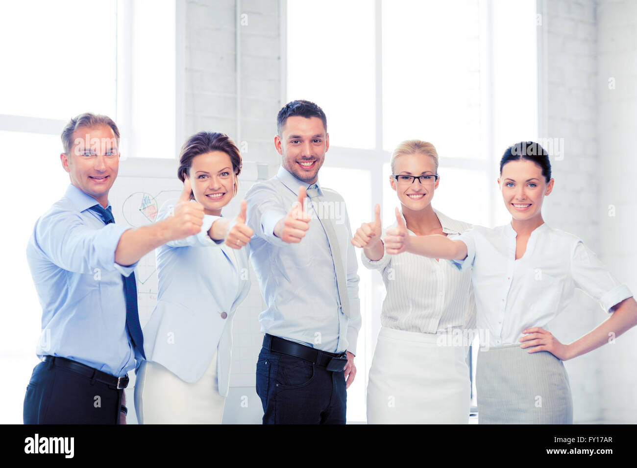 business team showing thumbs up in office Stock Photo - Alamy