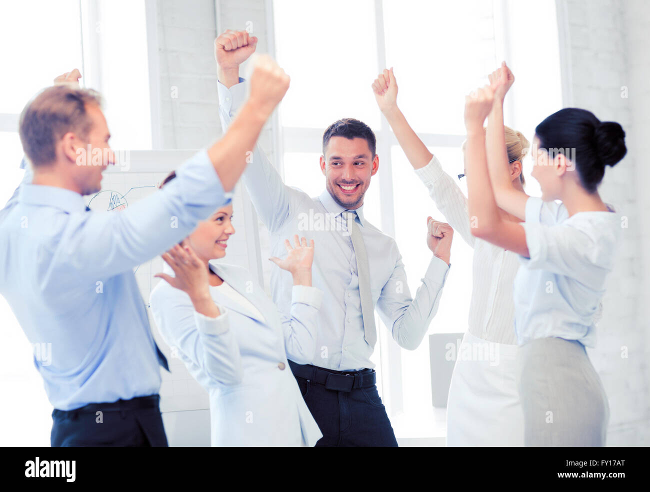business team celebrating victory in office Stock Photo - Alamy