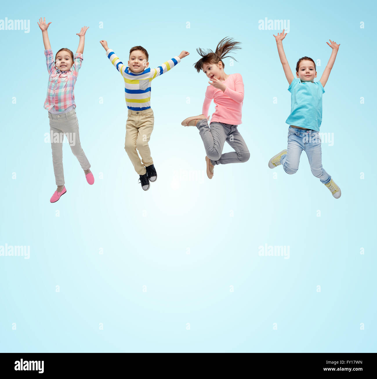 happy little children jumping in air over blue Stock Photo - Alamy