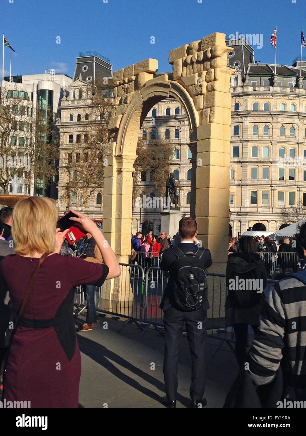 London, UK. 19th April, 2016. Crowds photographing and enjoying a recreation of the Arch of Triumph from Syria's ancient city of Palmyra.  The arch has been recreated by 3D printing and will travel the world. Credit:  Amanda Lewis/Alamy Live News Stock Photo