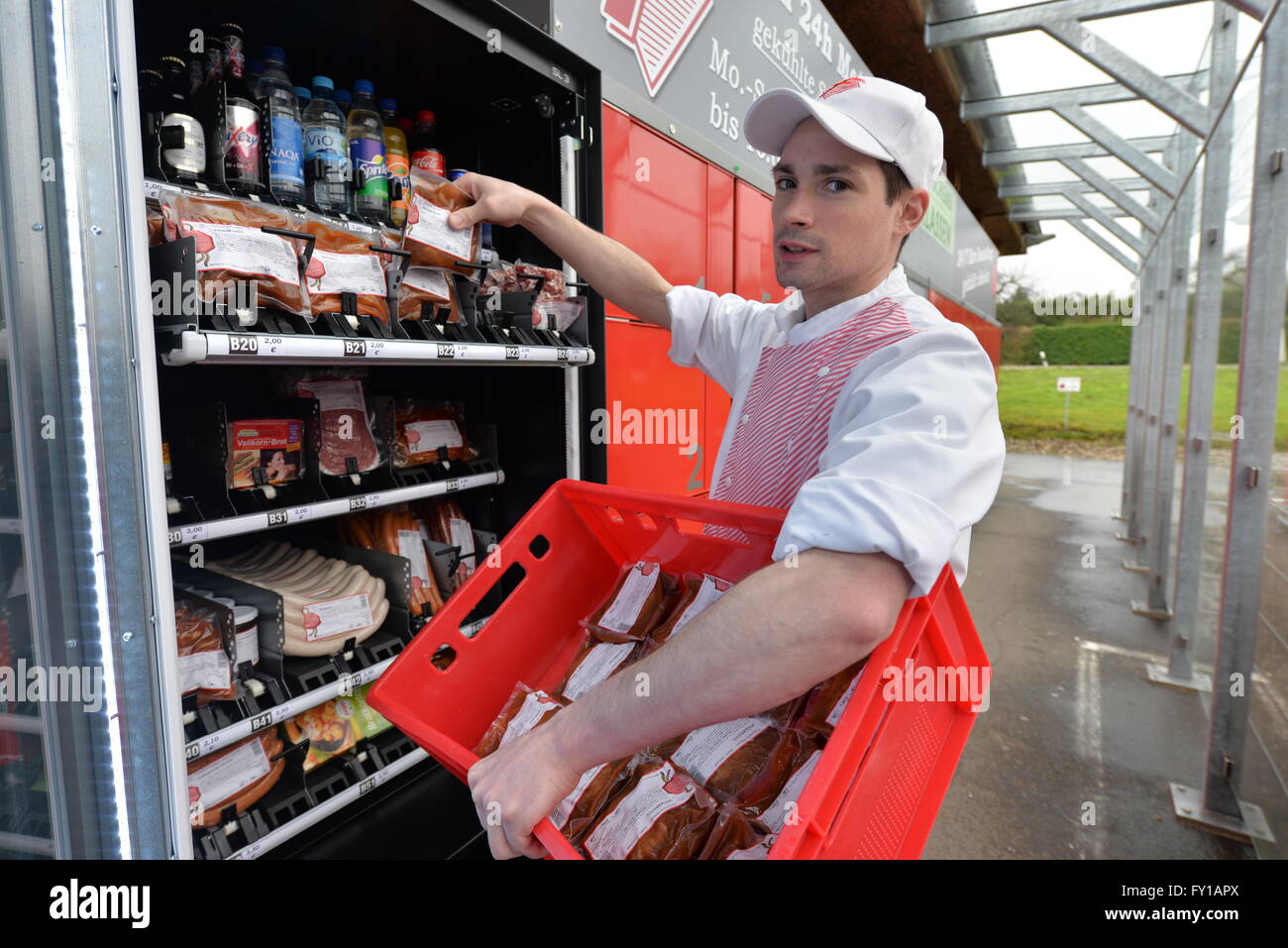 Temmels, Germany. 13th Apr, 2016. Butcher Philipp Klassen filling a vending machine with meat at the butcher shop Klassen, in Temmels, Germany, 13 April 2016. Next to their locker construction with payment function where clients can pick up their meat any time a day using a PIN code, Klassen also offers a meat vending machine. PHOTO: HARALD TITTEL/dpa/Alamy Live News Stock Photo