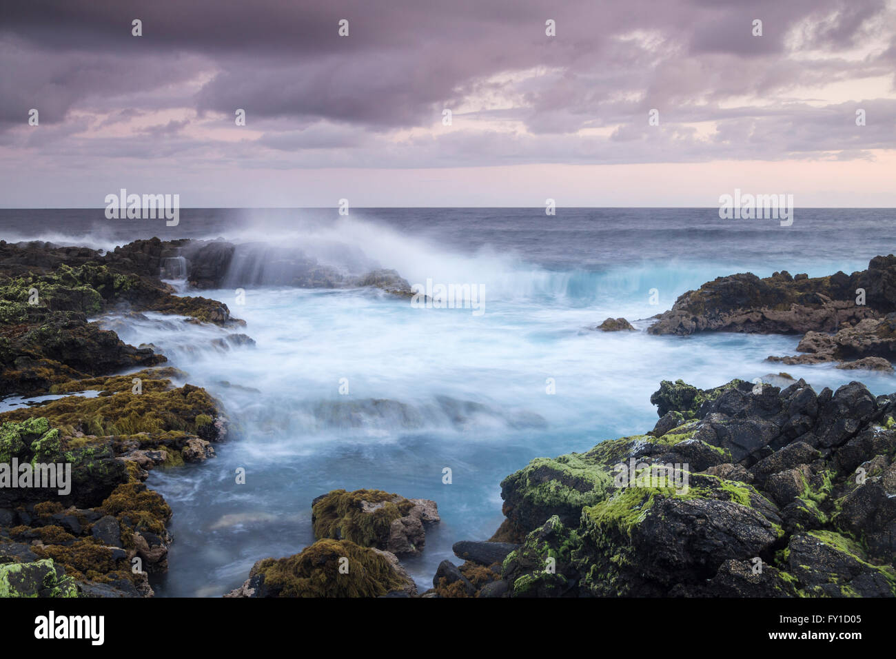 Las Palmas, Gran Canaria, Canary Islands, Spain, 20th April 2016. Weather: A glorious sunrise on Gran Canaria as photographer photographs waves crashing over rugged volcanic coast using long exposure in pre dawn light. Credit:  Alan Dawson News/Alamy Live News Stock Photo