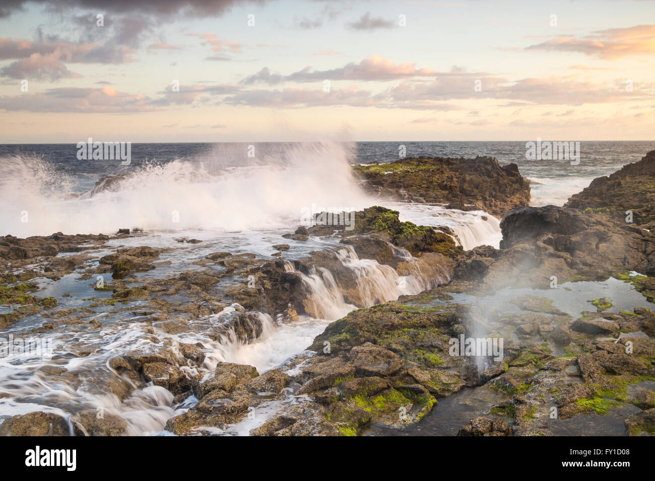 Las Palmas, Gran Canaria, Canary Islands, Spain, 20th April 2016. Weather: A glorious sunrise on Gran Canaria as photographer photographs waves crashing over rugged volcanic coast using long exposure in pre dawn light. Credit:  Alan Dawson News/Alamy Live News Stock Photo