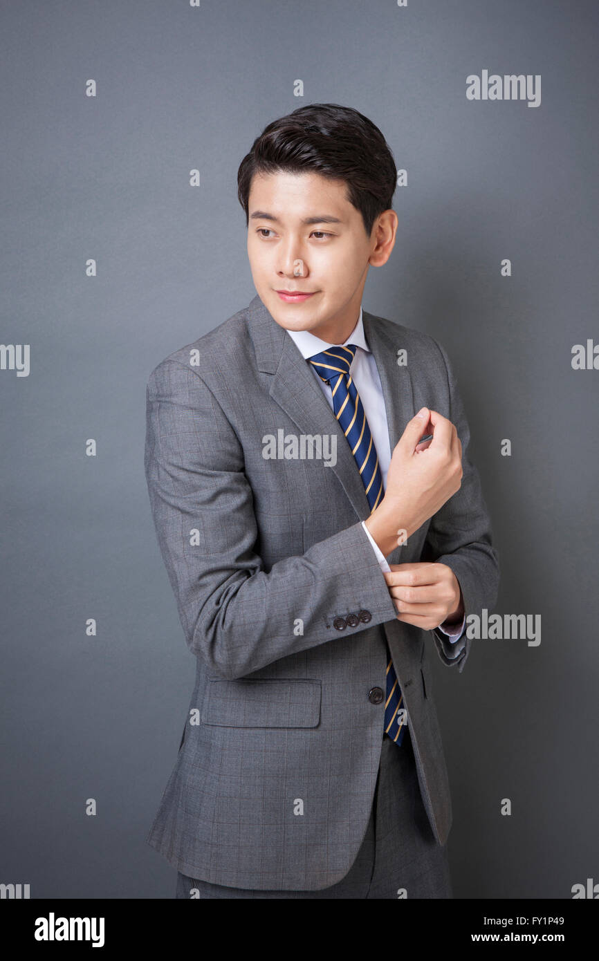 Young smiling business man in gray suit Stock Photo