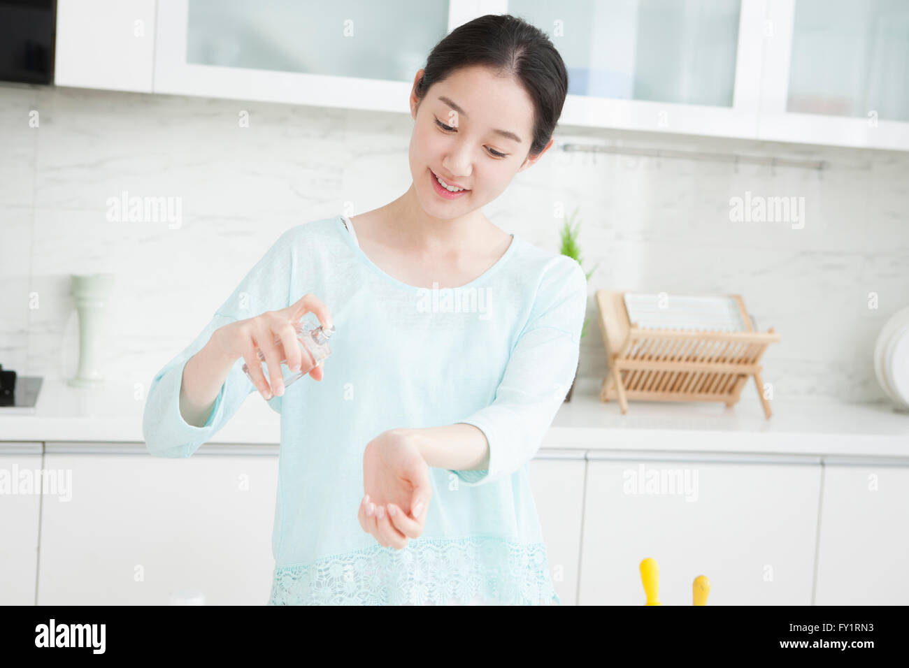 Young smiling woman spraying perfume Stock Photo Alamy