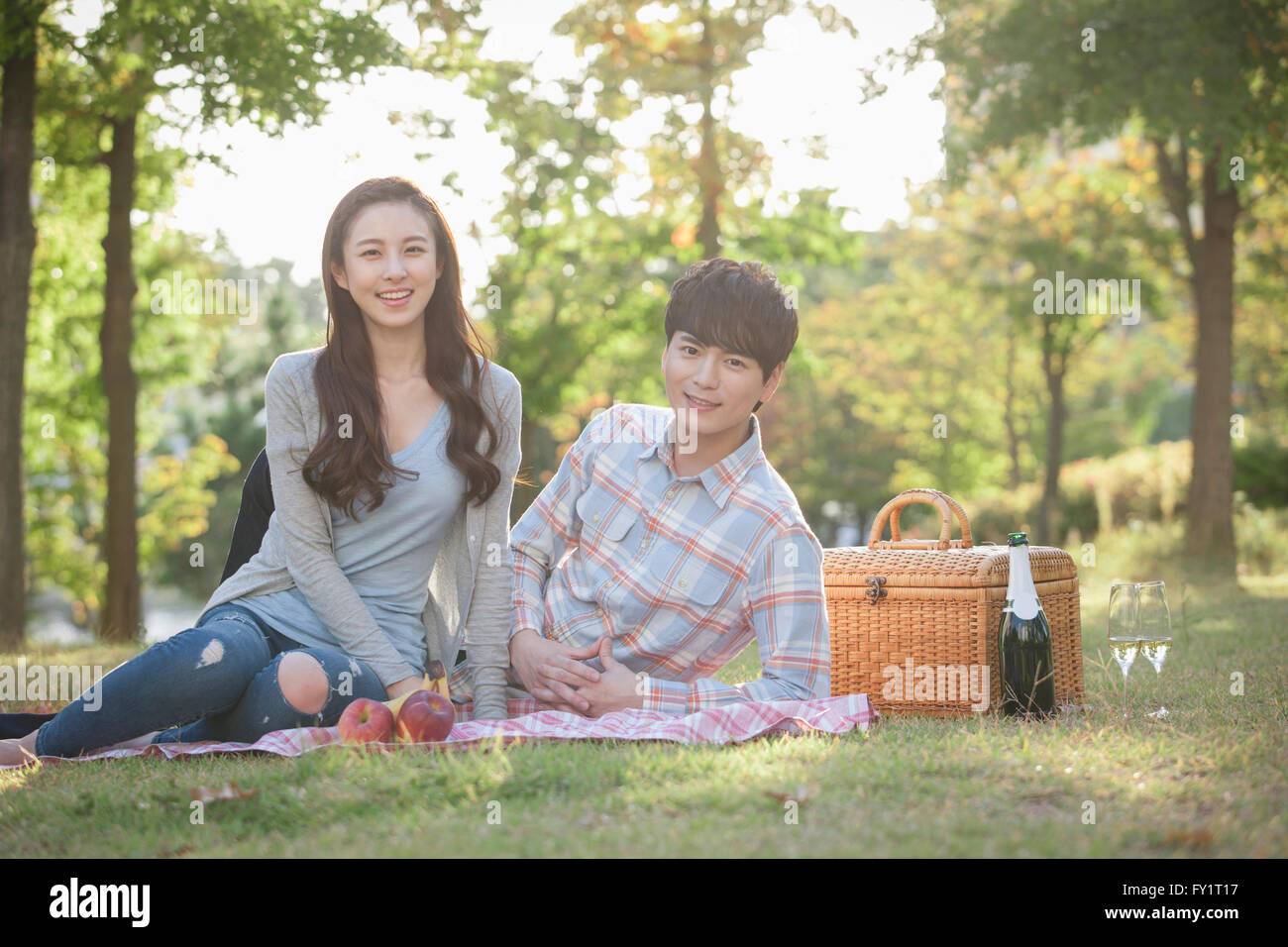 Young smiling couple having a picnic at park Stock Photo - Alamy