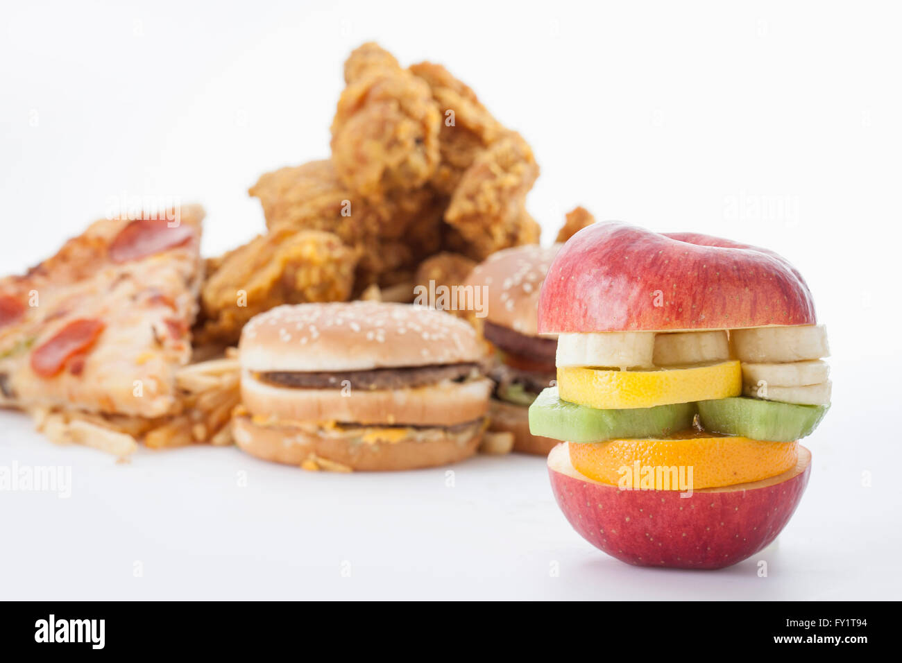Contrast of fast food and frsh fruit Stock Photo