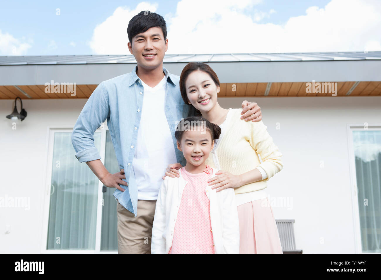 Family at the outside of their house representing rural life Stock Photo