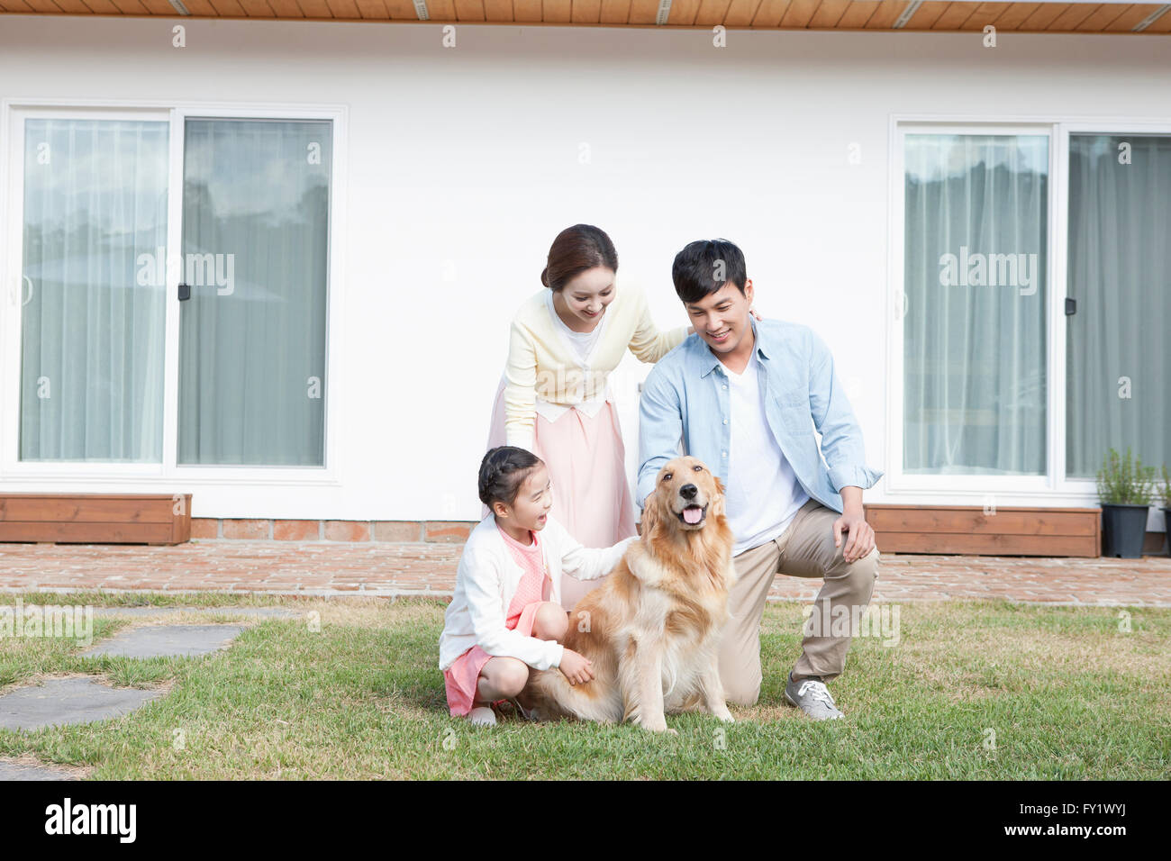 Family at the yard of their house representing rural life Stock Photo