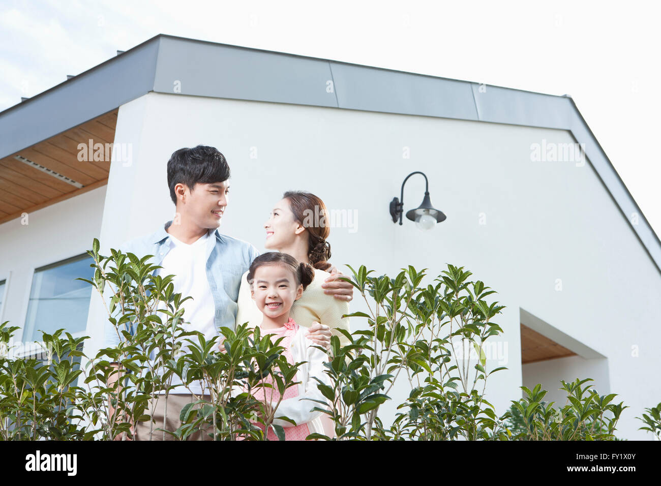 Family being happy at the yard of their house representing rural living Stock Photo