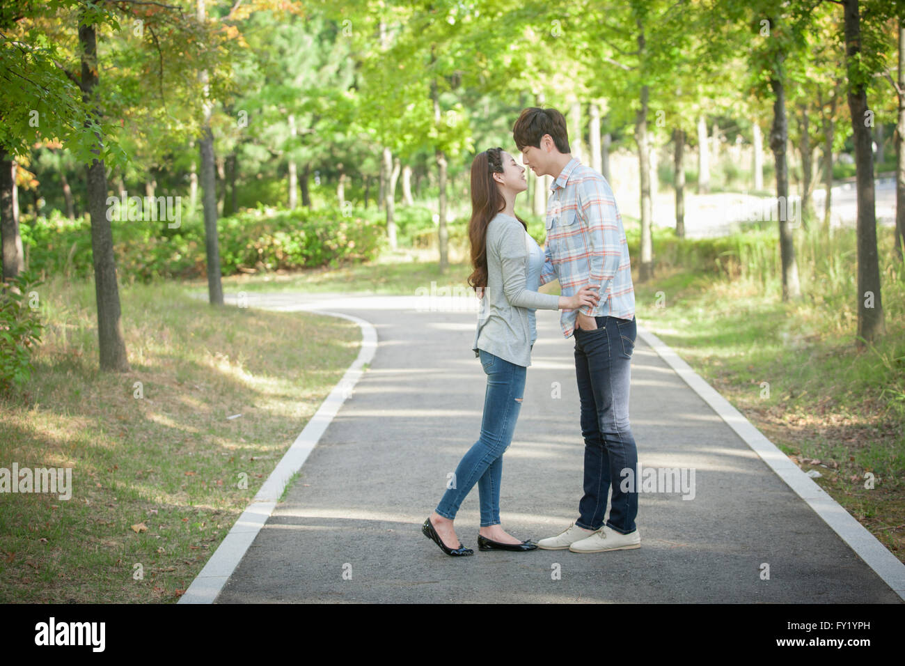 Couple facing at each other at the park Stock Photo