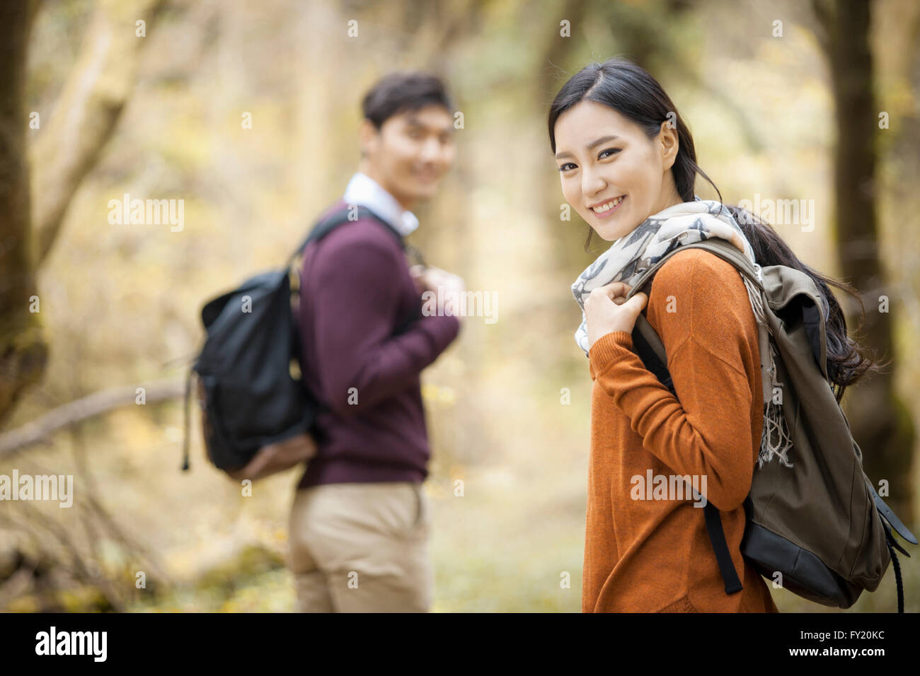 Couple taking a walk at the forest in fall Stock Photo - Alamy