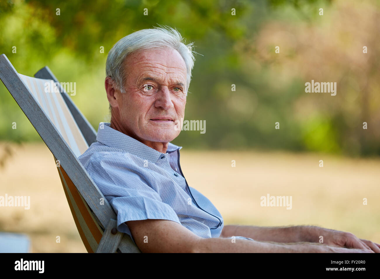Old man sitting on chair hi-res stock photography and images - Alamy
