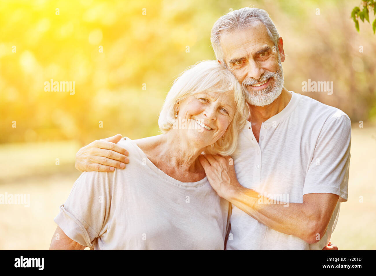 Happy senior couple in the garden in summer together Stock Photo - Alamy