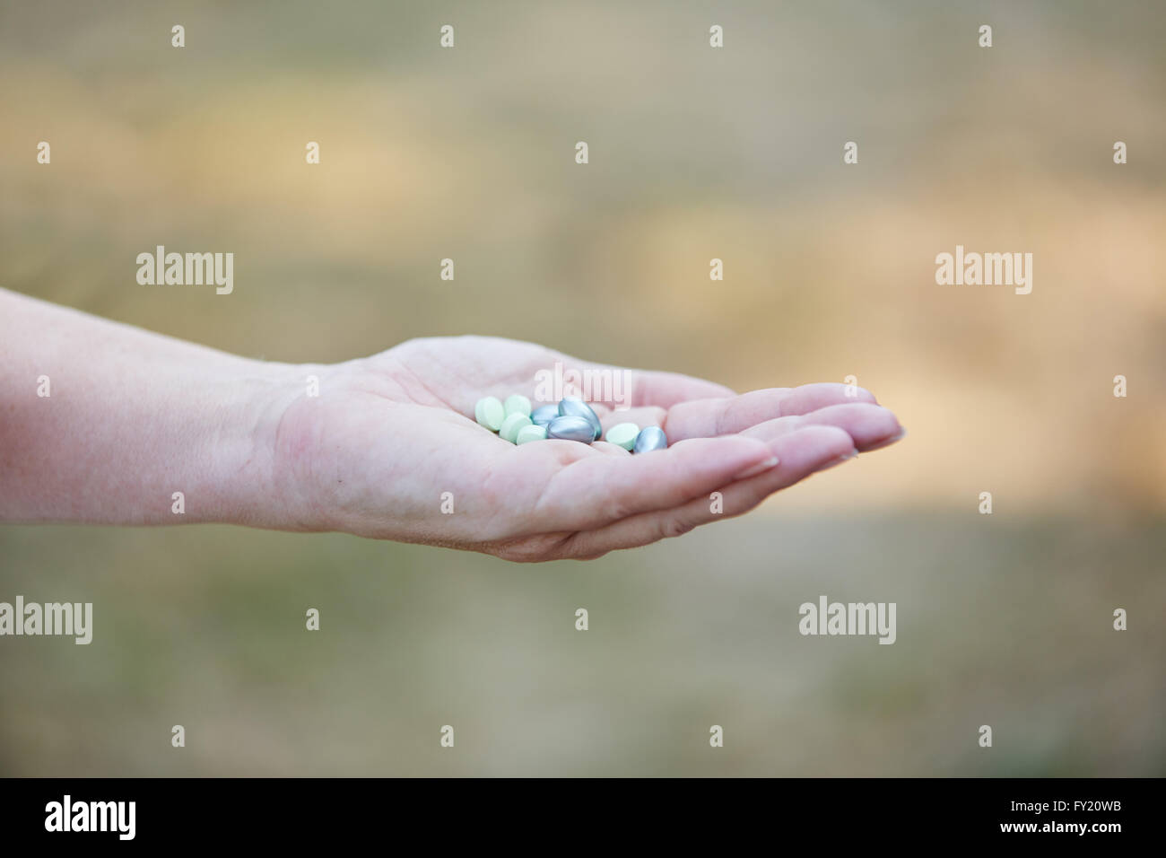 Tablets on the hand of a senior woman Stock Photo