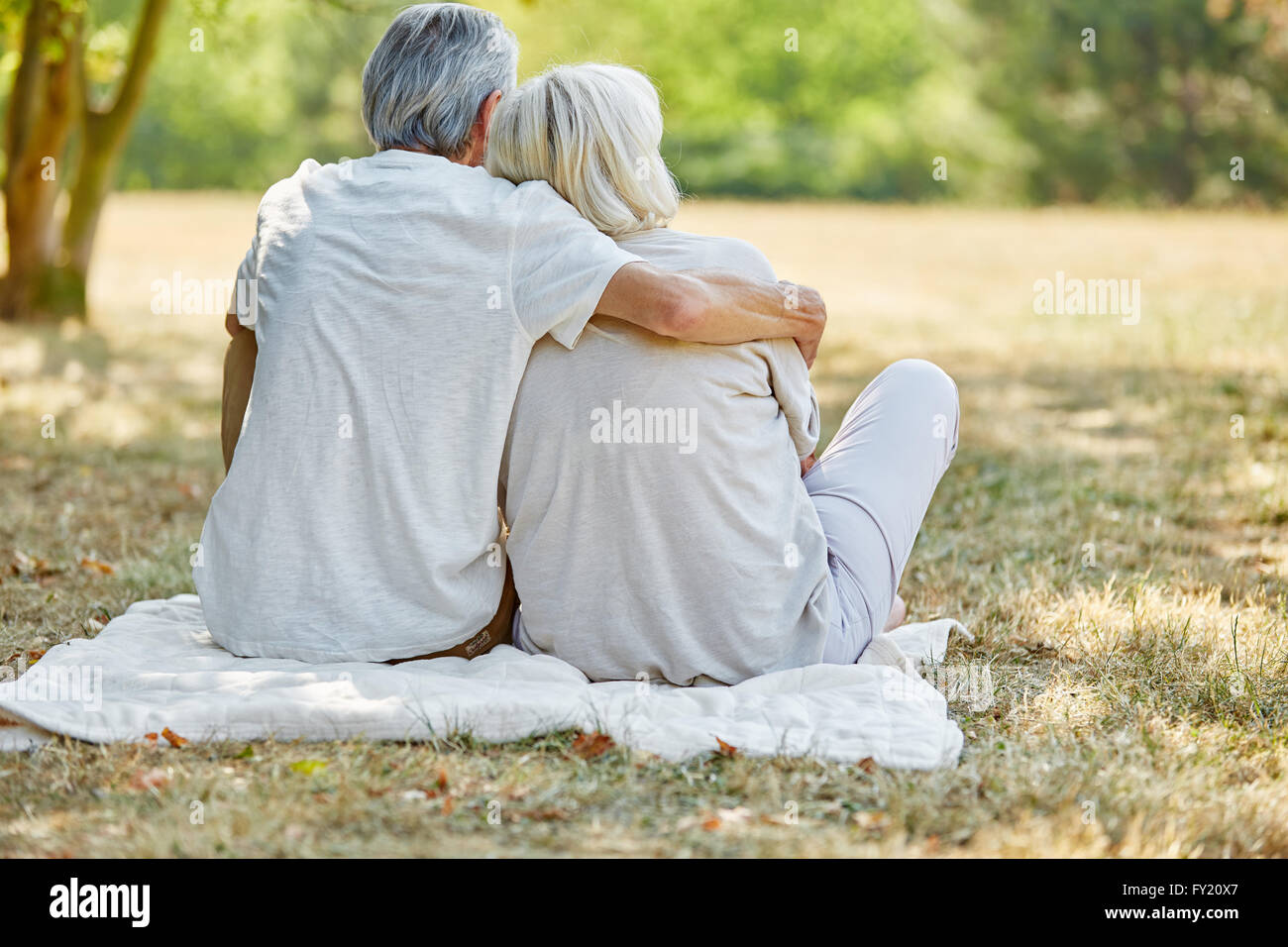 Happy senior couple in love sitting in the garden in summer Stock Photo ...
