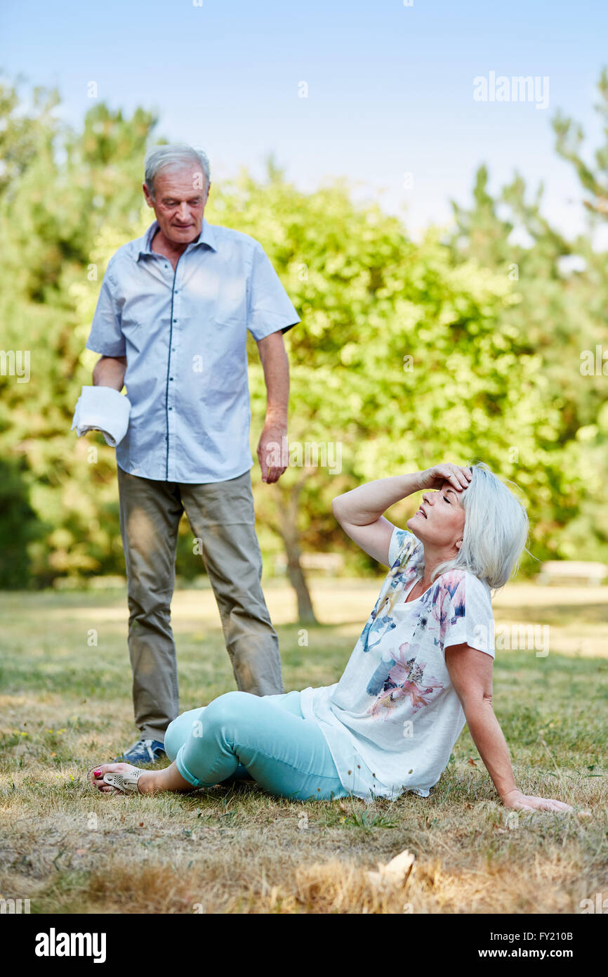 Senior man helps sick woman in the nature Stock Photo Alamy