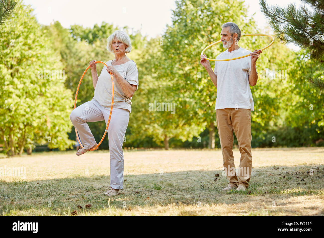 Seniors make gymnastics with tires in the summer and have fun Stock Photo