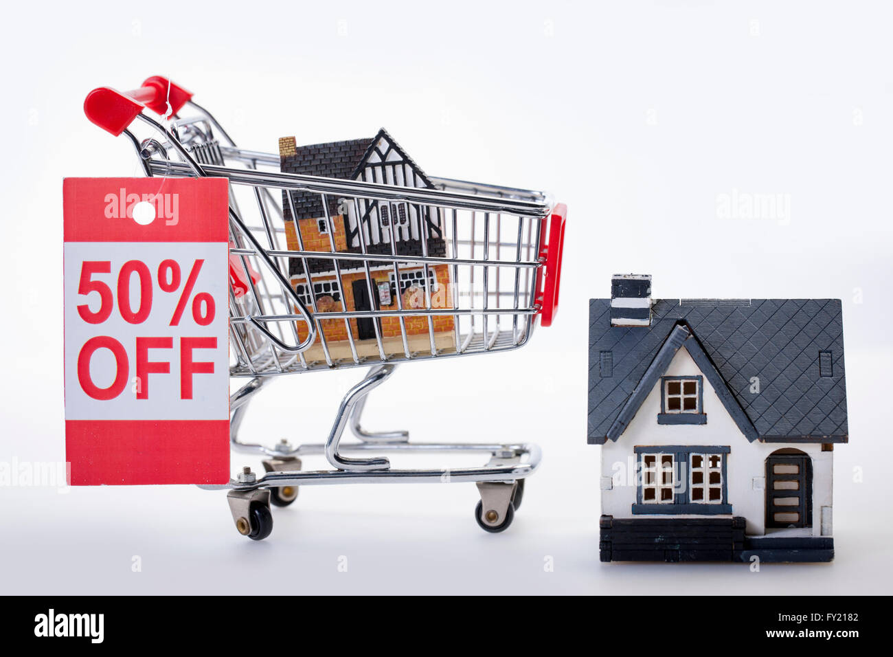 50 percent off sale sign on a cart with miniature houses Stock Photo