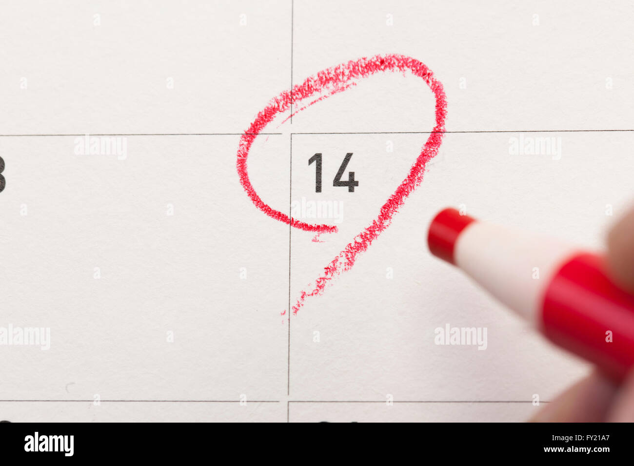 Calendar date 14 marked with red color with red color pencil Stock Photo