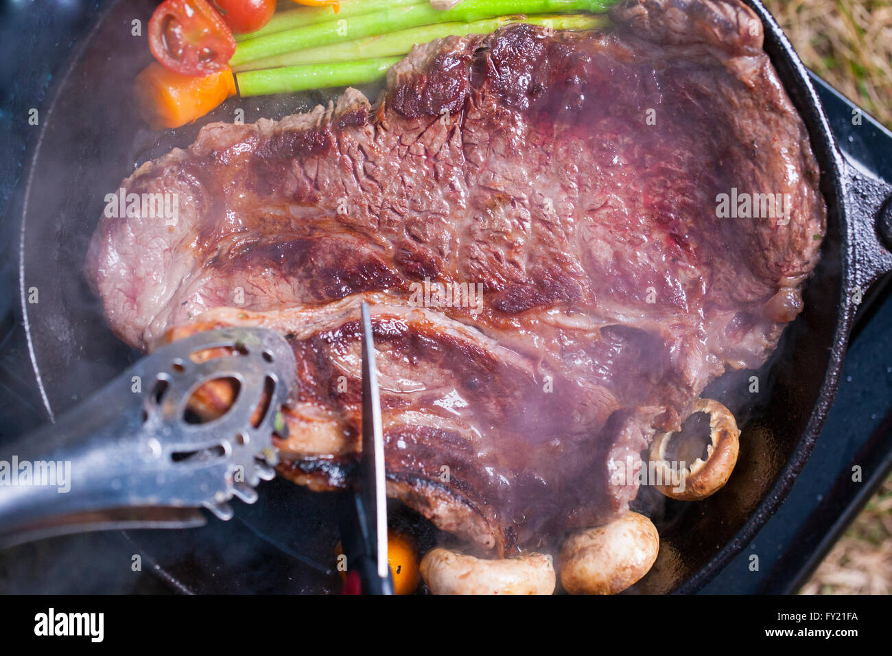 Cooked Trim Steak being cooked and cut Stock Photo - Alamy