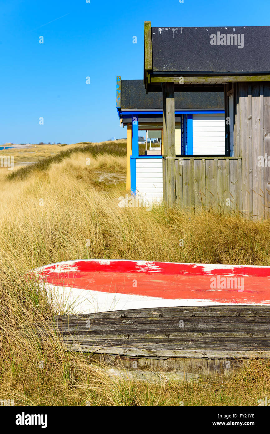 Boat keels in the grass beside a bathing hut at a beach one sunny and fine day. Stock Photo