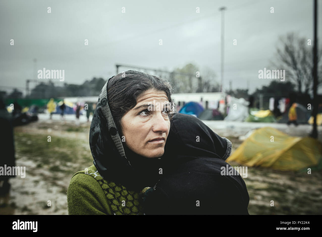 Mother with small child in her arms, refugee camp in Idomeni, border with Macedonia, Greece Stock Photo