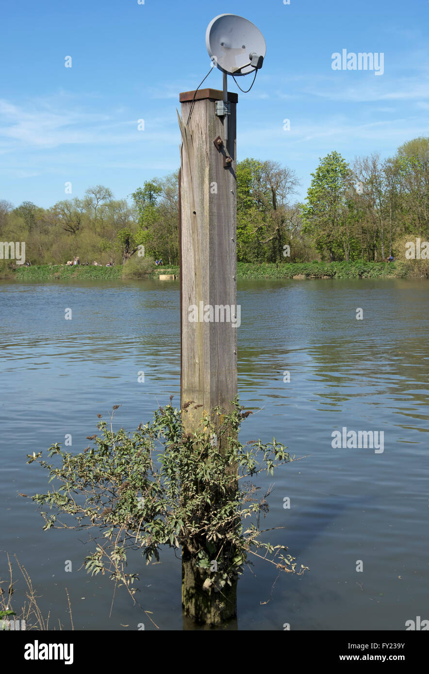 satellite dish mounted on a mooring post on the river thames at isleworth, middlesex, england Stock Photo