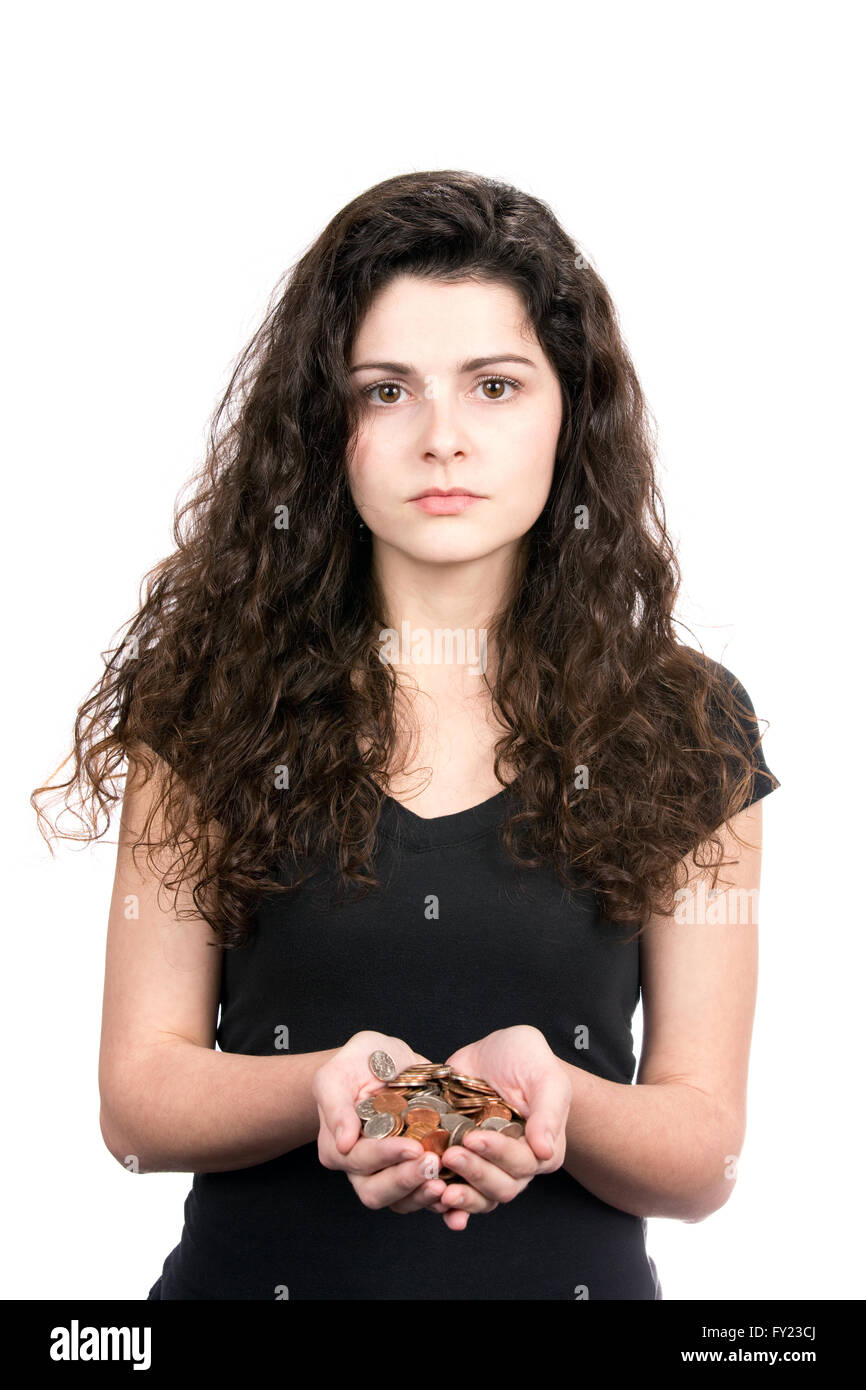 Successful young business woman holds a handful of coins showing savings, spending or financial concepts. Stock Photo