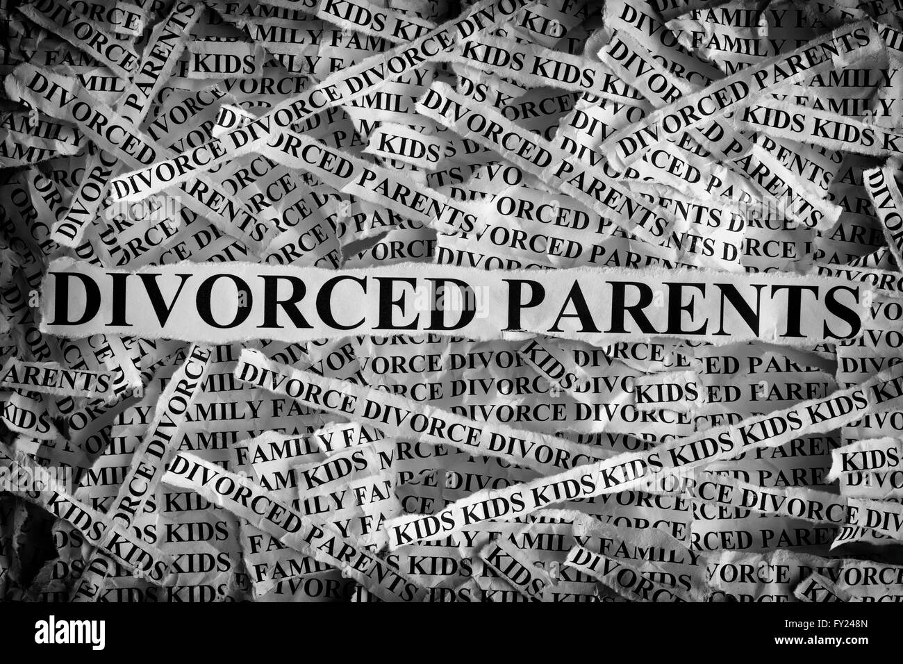 Torn pieces of paper with the words Divorced parents. Concept Image. Black and White. Closeup. Stock Photo