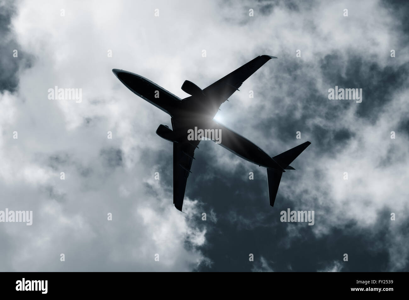 Aircraft silhouette directly above Stock Photo