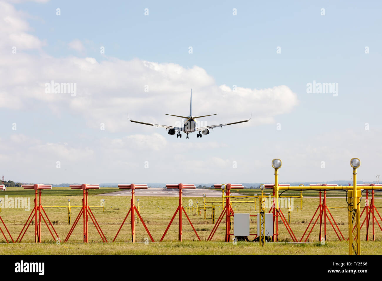 Passenger aircraft landing on runway Stock Photo