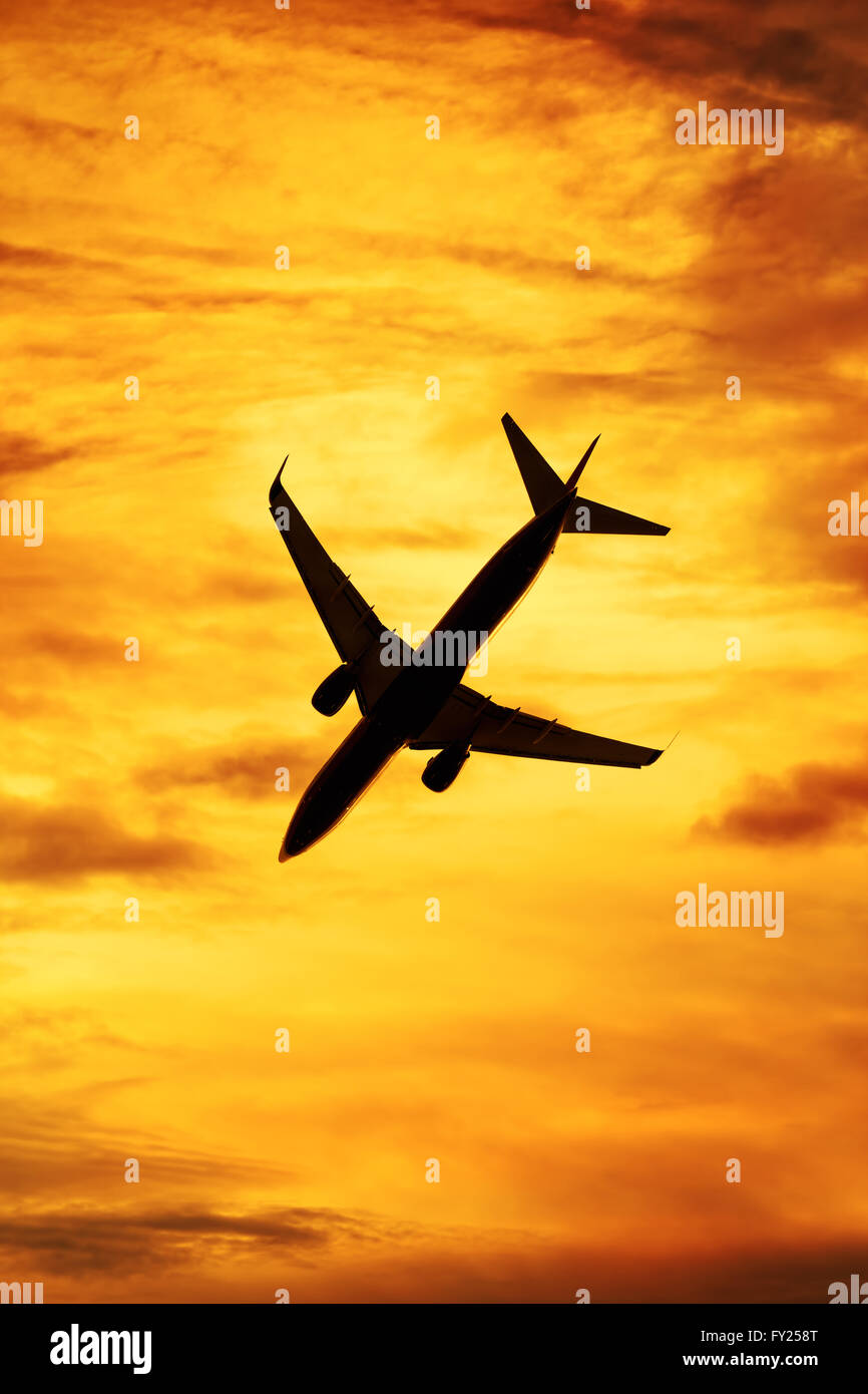 Sunset silhouette of passenger aircraft Stock Photo