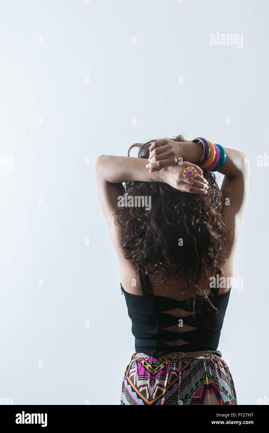 Rear view of a young woman hands on head Stock Photo - Alamy
