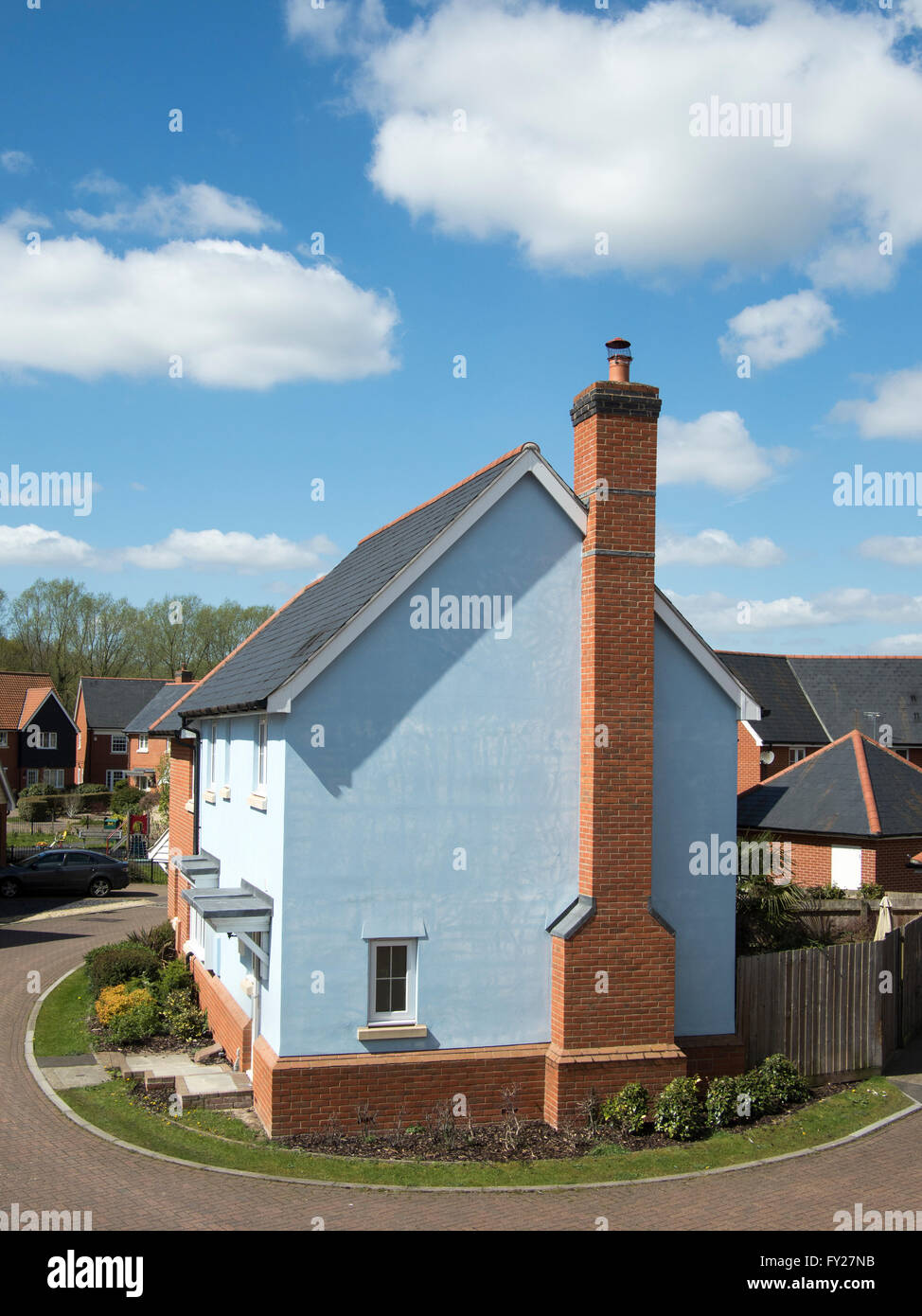 The exterior of a blue-walled British house with chimney. Stock Photo