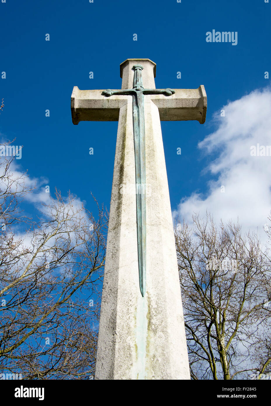 A stone cross with metal sword - part of a war memorial in Sudbury, Suffolk. Stock Photo