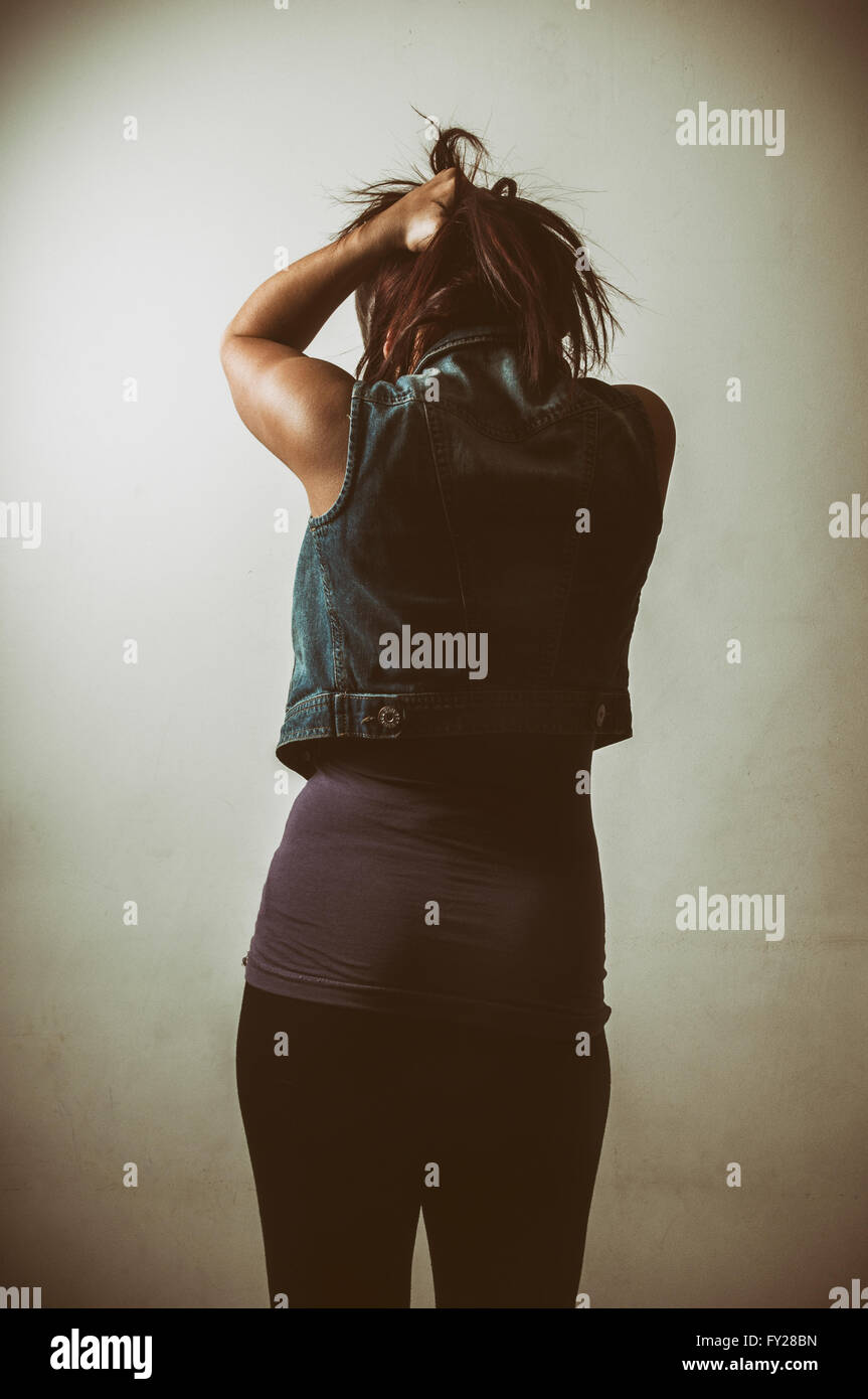 Rear view of a frustrated young woman pulling her hair Stock Photo - Alamy