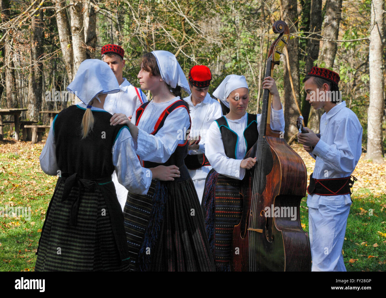 People playing folk instruments dresses in traditional costume on Plitvice lakes in Croatia Stock Photo