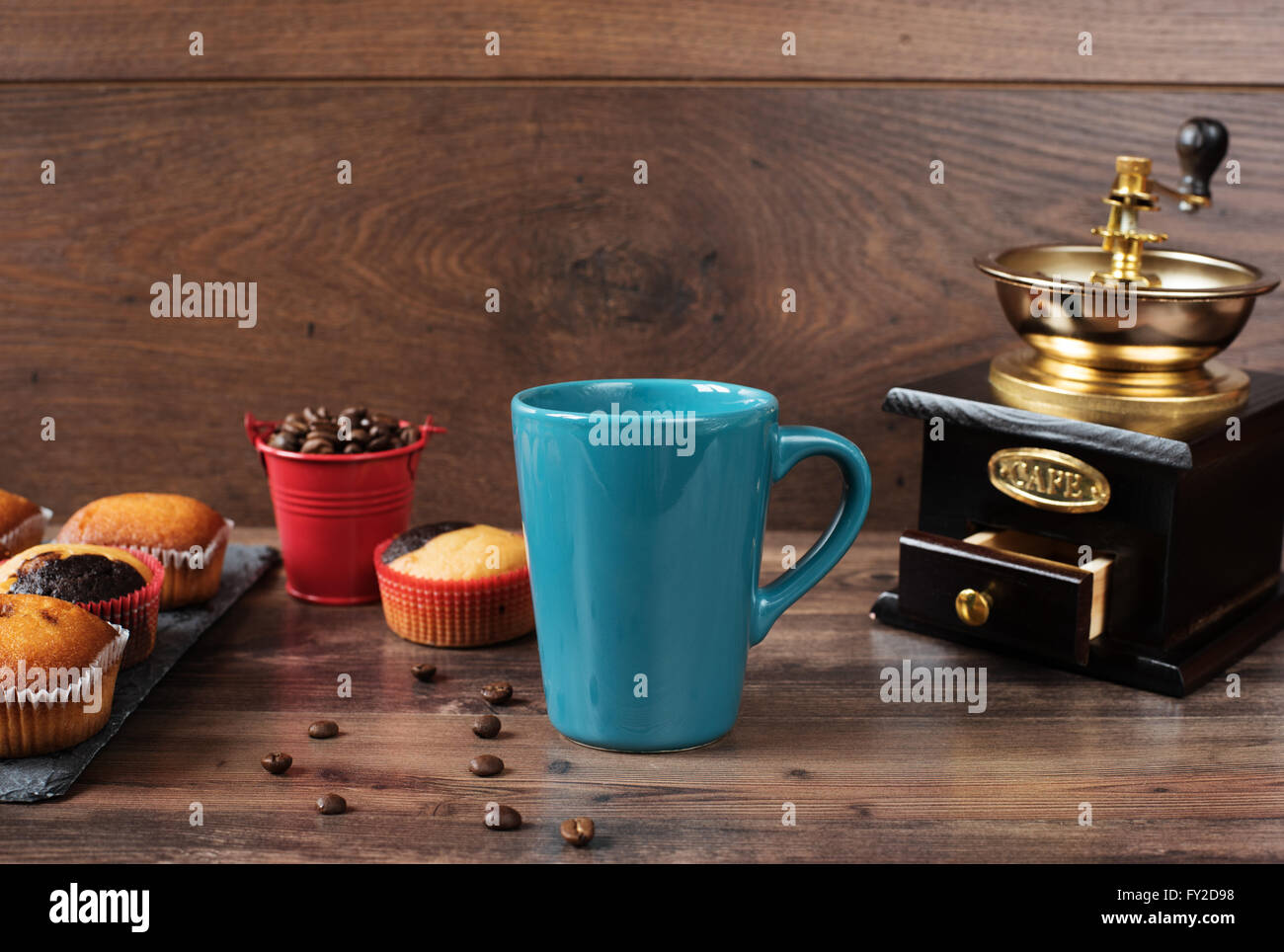 Retro coffee grinder, coffee mill coffee cup, chocolate cupcake, muffins, coffee beans. Still