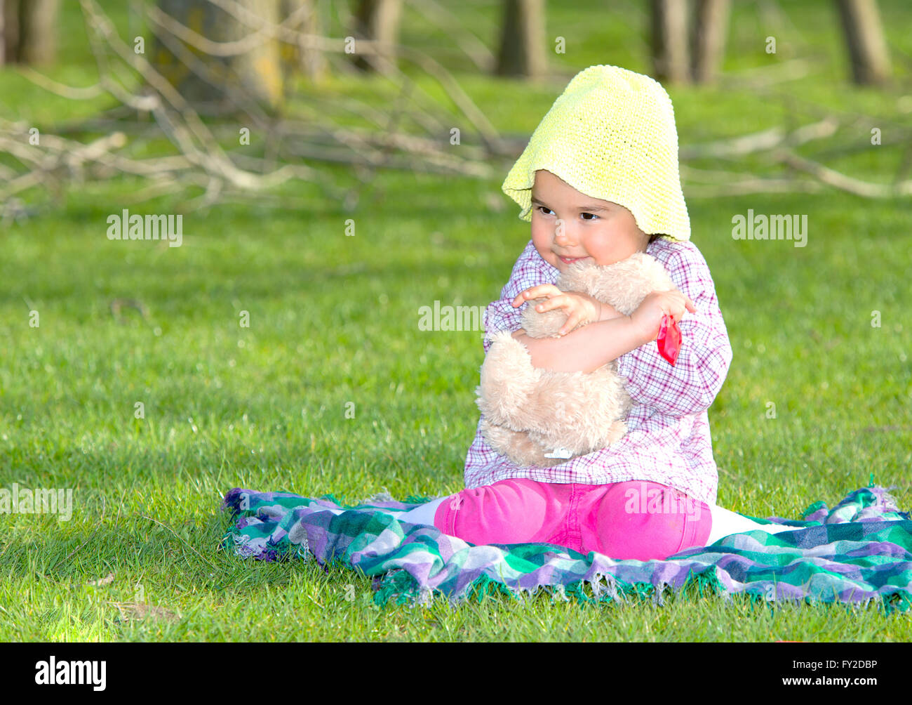 Little girl with teddy bear on nature Stock Photo - Alamy