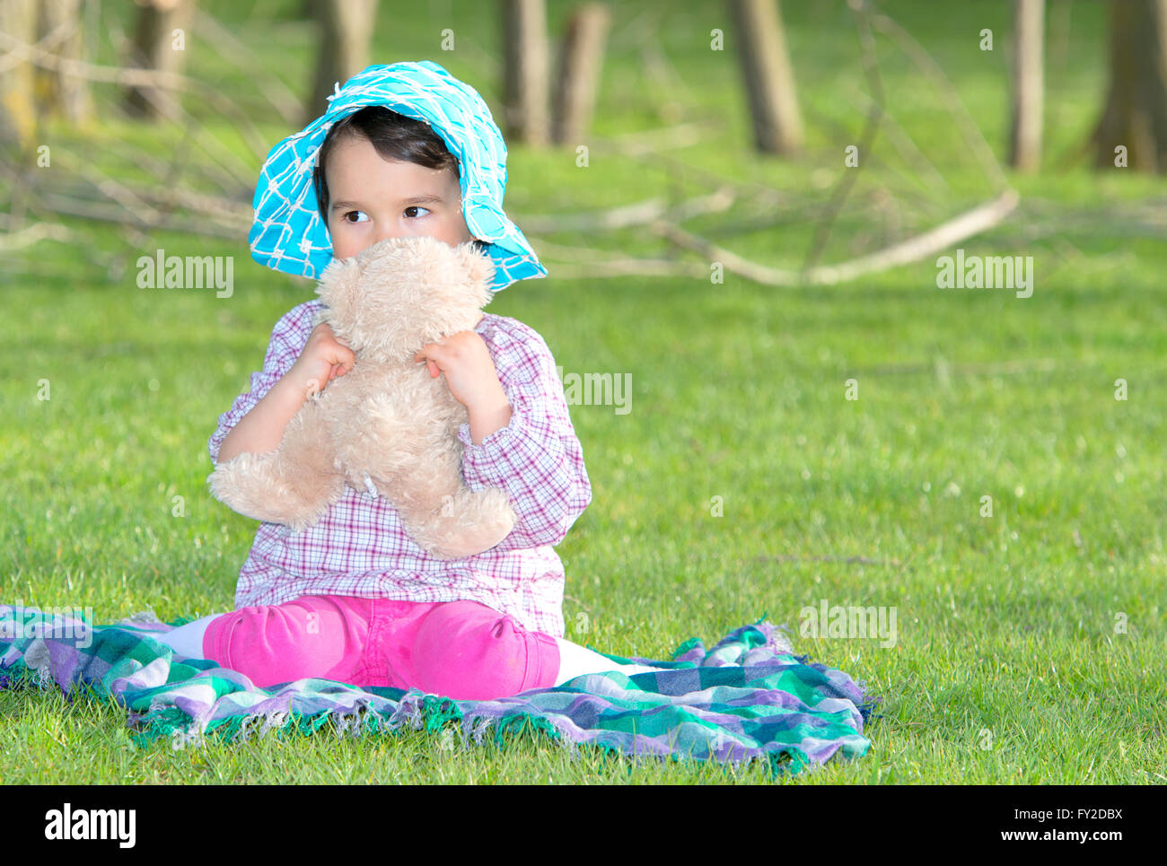 Little girl with teddy bear on nature Stock Photo - Alamy