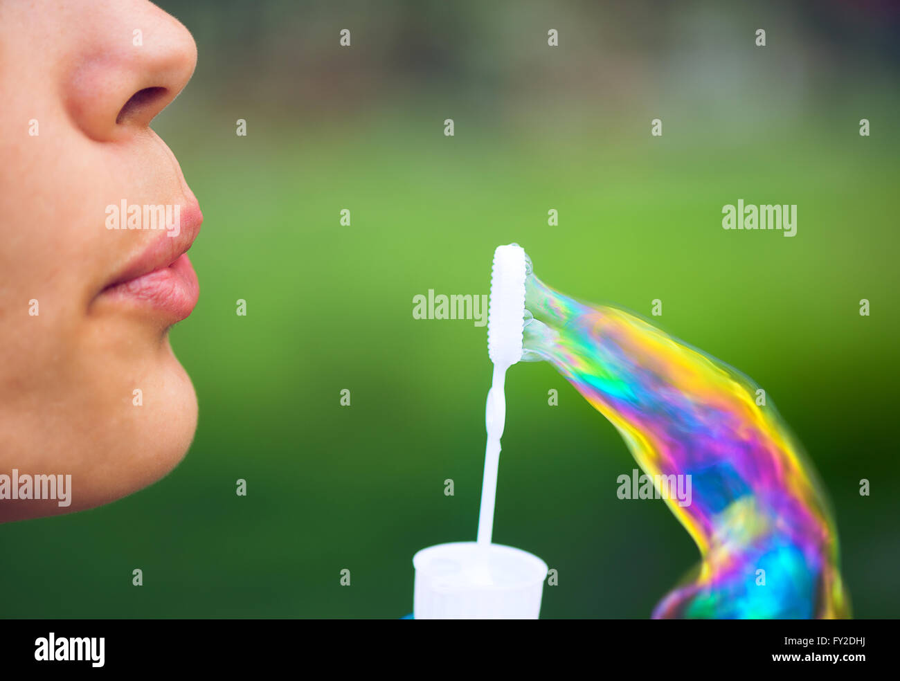 Woman blowing soap bubbles Stock Photo