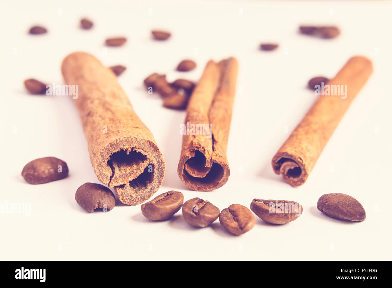 Close up of cinnamon sticks and coffee beans in blurred background. Stock Photo