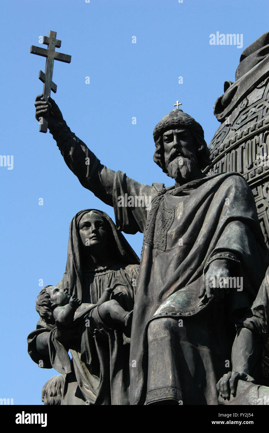 Grand Prince Vladimir the Great. Detail of the Monument to the Millennium of Russia (1862) designed by Russian sculptor Mikhail Mikeshin in Veliky Novgorod, Russia. The statue of Prince Vladimir the Great represents the Christianization of Kievan Rus (988). Vladimir the Great is depicted raising an Orthodox cross. Besides him a woman holds her child for baptism. Stock Photo