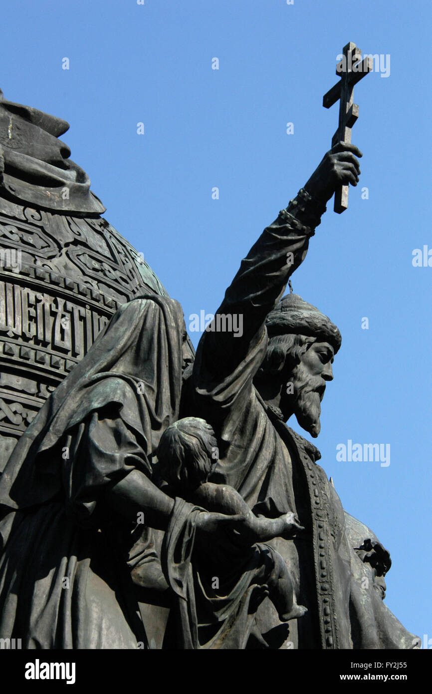 Grand Prince Vladimir the Great. Detail of the Monument to the Millennium of Russia (1862) designed by Russian sculptor Mikhail Mikeshin in Veliky Novgorod, Russia. The statue of Prince Vladimir the Great represents the Christianization of Kievan Rus (988). Vladimir the Great is depicted raising an Orthodox cross. Besides him a woman holds her child for baptism. Stock Photo